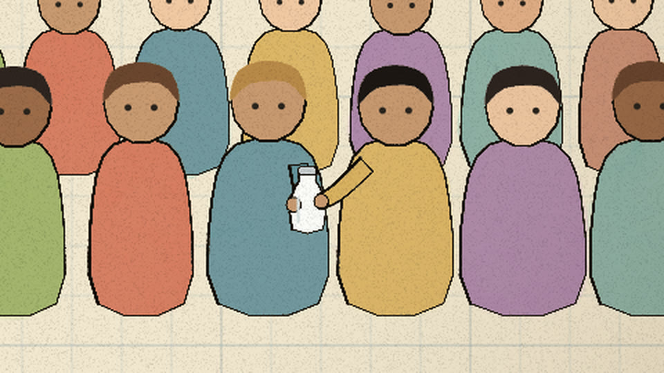 One person in the crowd hands the next a bottle of milk
