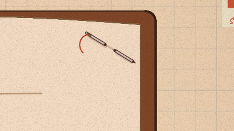 A sewing needle with red thread pinned through a page’s corner