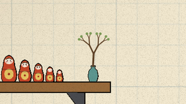 A forking twig in a small teal vase at the end of her shelf