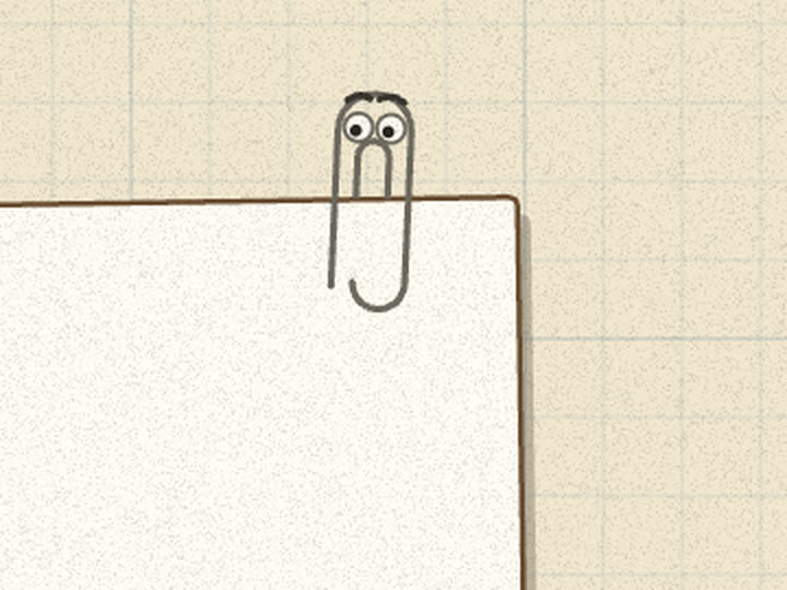 A wire paperclip with eyes and brows clipped to the top of the letter